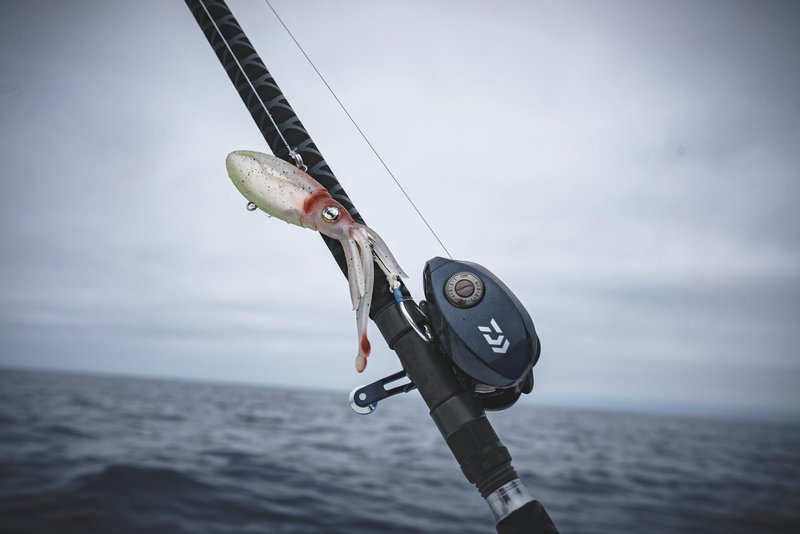 Nomad Design Squidtrex Patented Vibrating Fishing Lure- Scent Added TPE Soft Plastic Lure for Saltwater w/Strong BKK Assist Hooks, Fishing Bait that catches many species,110mm,1 3/4oz Green Gold Gizzy