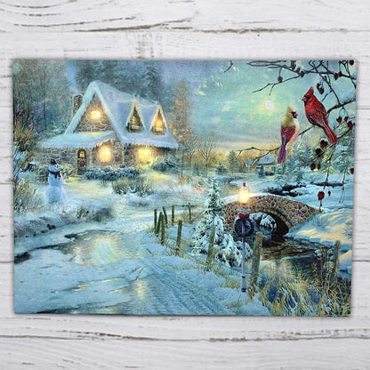 BANBERRY DESIGNS LED Christmas Wall Art - Lighted Cottage Along a Stream Christmas Scene with Cardinals and Snowman - LED Canvas Prints - Old Fashioned Cobblestone Bridge - Measures 11.75" x15.75"