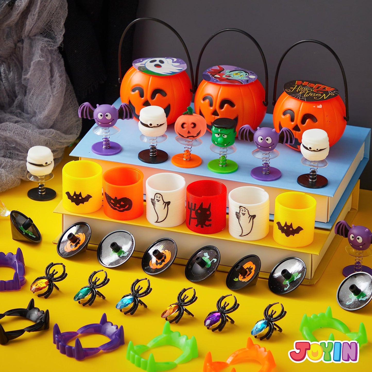 JOYIN 144 PCS Halloween Toy Gifts for Kid Trick or Treating, 24 Pack Prefilled Mini Pumpkin Buckets with Spider Ring, Popper, Spring, Vampire Teeth and Spinning Top, Halloween Party Favors Supplies